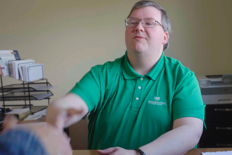 Lending specialist shaking hands with member