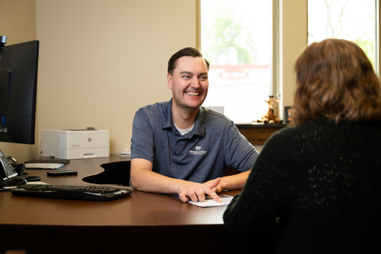 Lending Manager smiling at desk