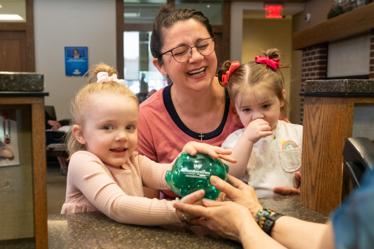 girl holding piggy bank